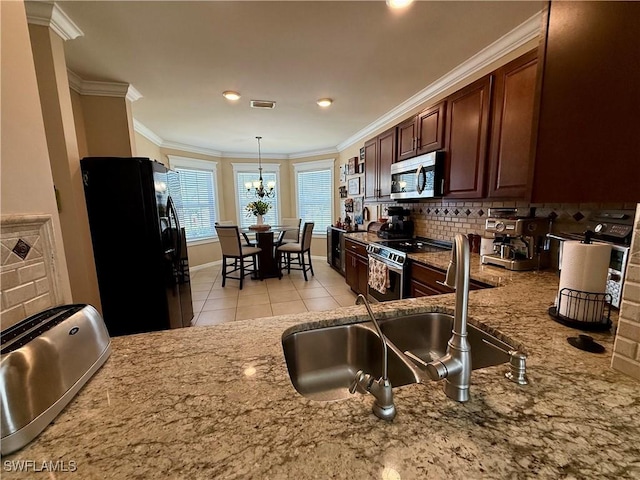 kitchen with tasteful backsplash, visible vents, ornamental molding, and stainless steel appliances