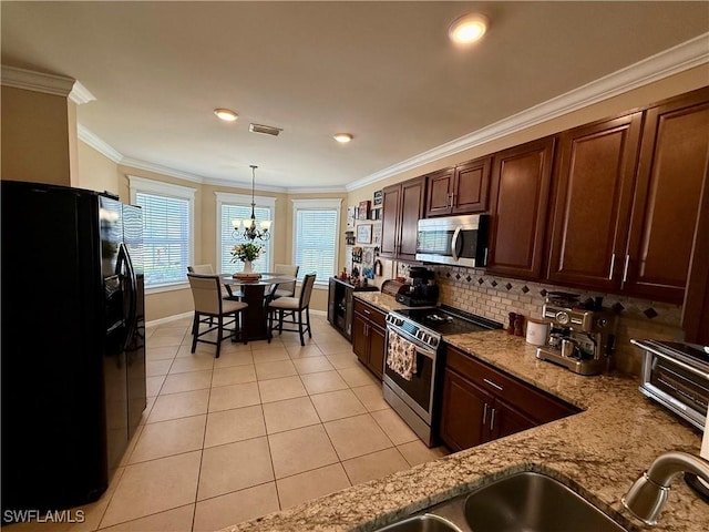 kitchen with crown molding, visible vents, appliances with stainless steel finishes, and light tile patterned flooring