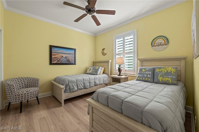 bedroom with baseboards, ornamental molding, ceiling fan, and wood finished floors