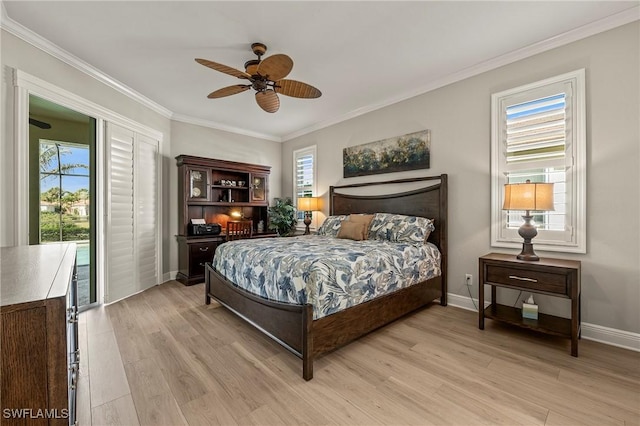 bedroom featuring a ceiling fan, light wood-style flooring, baseboards, and crown molding