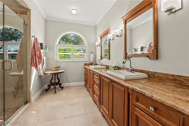 full bathroom with ornamental molding, a stall shower, a sink, and tile patterned floors