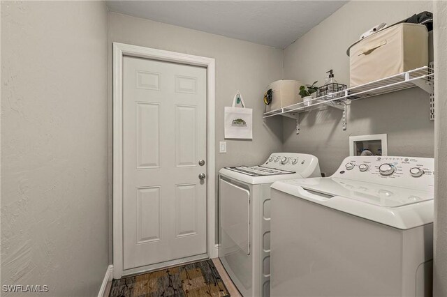 washroom with laundry area, baseboards, dark wood-style flooring, and separate washer and dryer