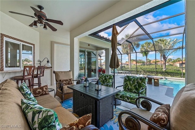 sunroom featuring a ceiling fan