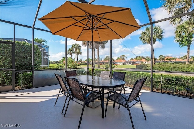 view of patio featuring glass enclosure and outdoor dining space