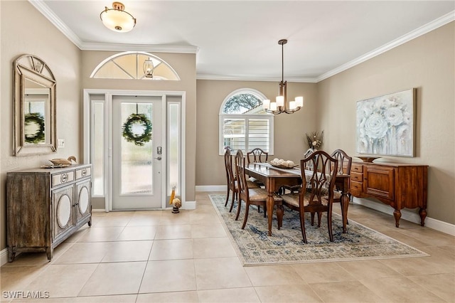 dining area featuring a chandelier, ornamental molding, light tile patterned floors, and baseboards