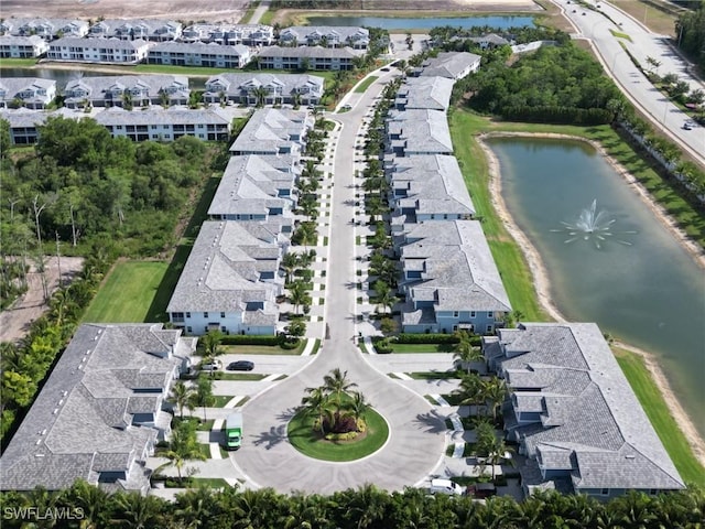 bird's eye view featuring a water view and a residential view