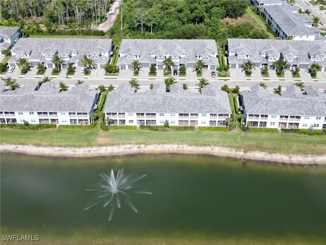 birds eye view of property featuring a water view and a residential view