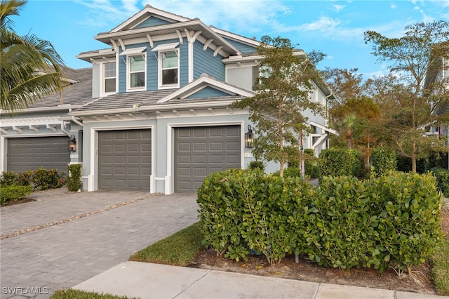 view of front facade with decorative driveway and an attached garage