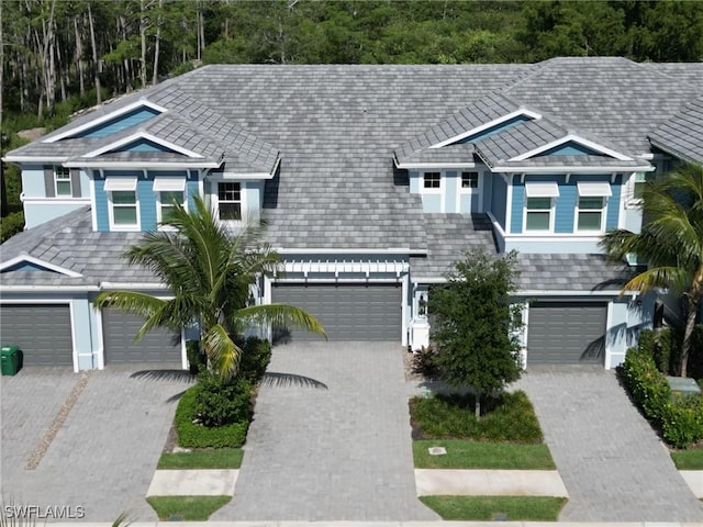 view of front of property with a garage, driveway, and stucco siding