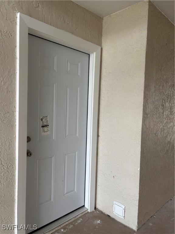 doorway to property with stucco siding