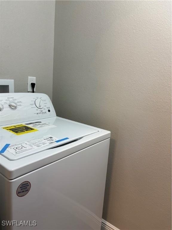 clothes washing area featuring laundry area and washer / clothes dryer