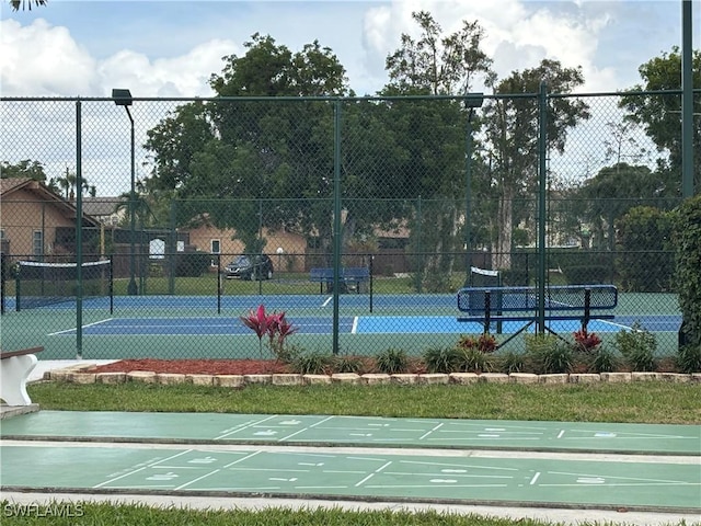 view of tennis court with fence