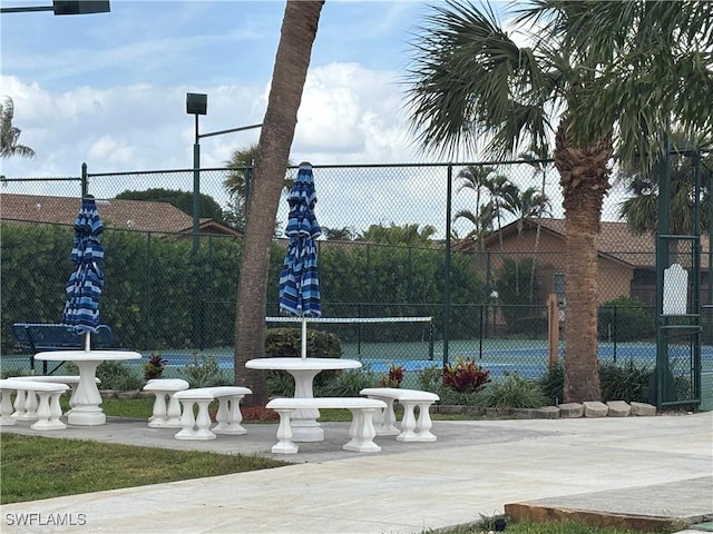 view of sport court featuring fence