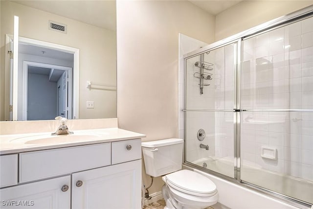 full bathroom with combined bath / shower with glass door, visible vents, toilet, and vanity