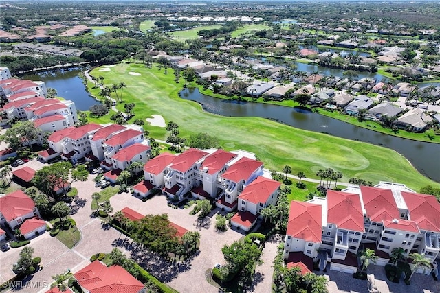 bird's eye view featuring golf course view, a water view, and a residential view