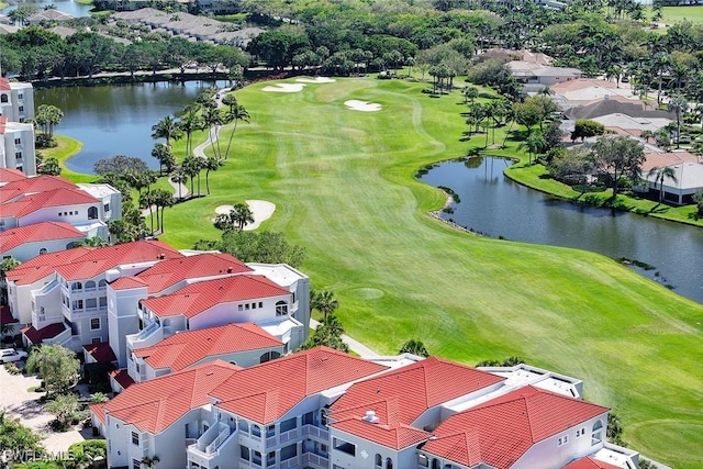 aerial view featuring a residential view, golf course view, and a water view