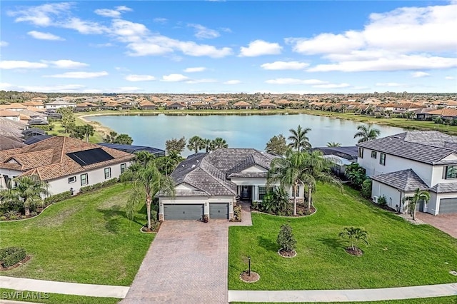 drone / aerial view featuring a water view and a residential view