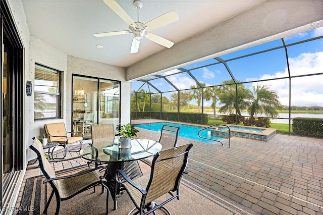 view of pool featuring a lanai, ceiling fan, a pool with connected hot tub, and a patio