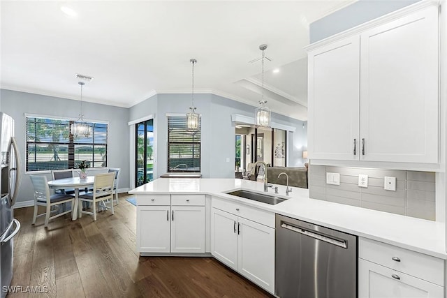 kitchen with a sink, stainless steel appliances, dark wood-type flooring, and light countertops