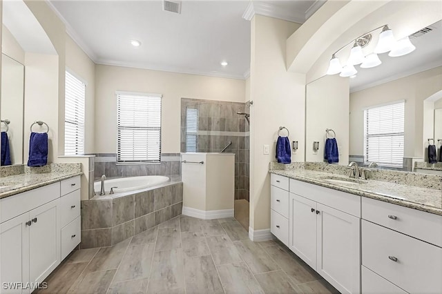 full bath with visible vents, a walk in shower, crown molding, and a sink