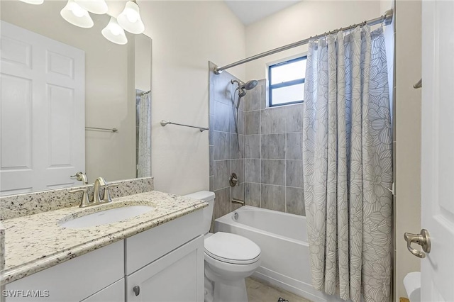 full bathroom with vanity, toilet, shower / bath combo with shower curtain, and a chandelier