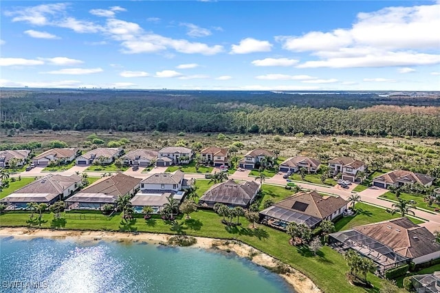 drone / aerial view featuring a residential view and a water view