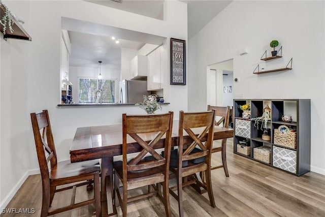 dining room featuring baseboards and wood finished floors