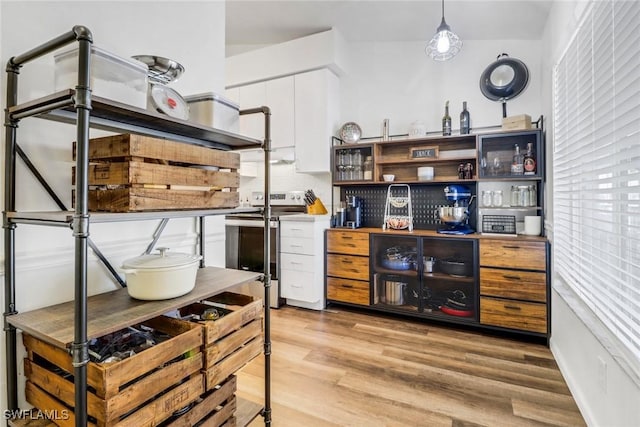 kitchen featuring white cabinetry, light wood finished floors, open shelves, tasteful backsplash, and stainless steel range with electric stovetop