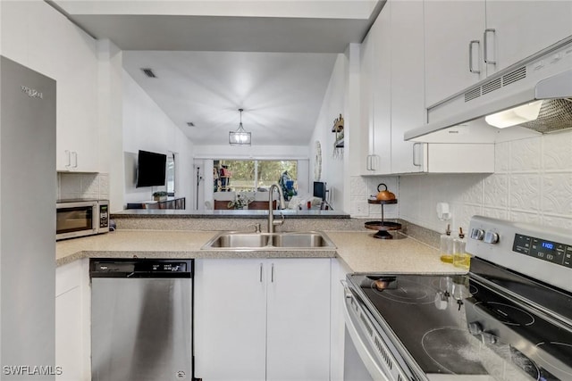 kitchen with under cabinet range hood, appliances with stainless steel finishes, white cabinets, and a sink