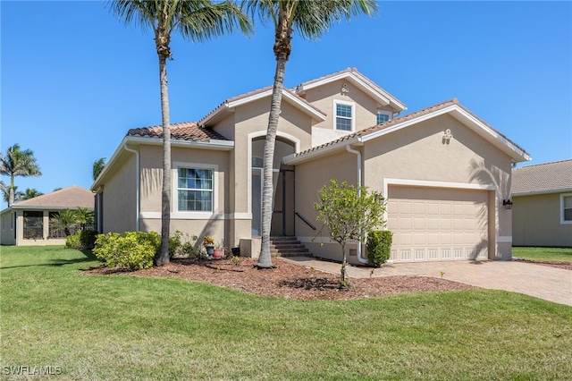 mediterranean / spanish-style house with a garage, a tiled roof, decorative driveway, stucco siding, and a front yard