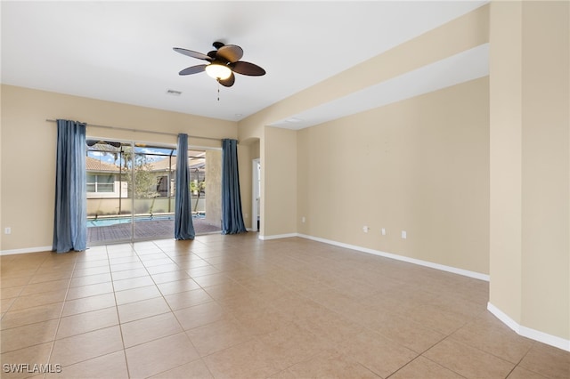 empty room with light tile patterned floors, visible vents, baseboards, and a ceiling fan