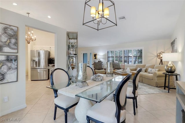 dining area with light tile patterned flooring, visible vents, and a notable chandelier