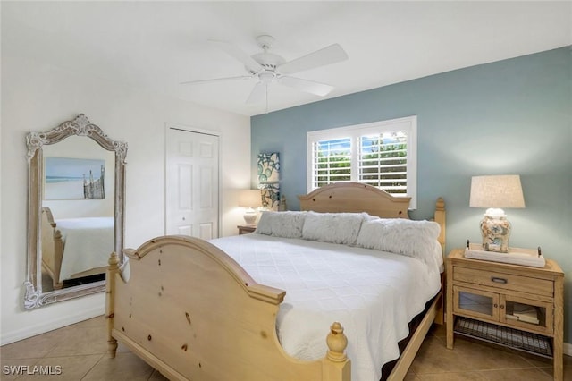 bedroom with a ceiling fan, a closet, and light tile patterned floors