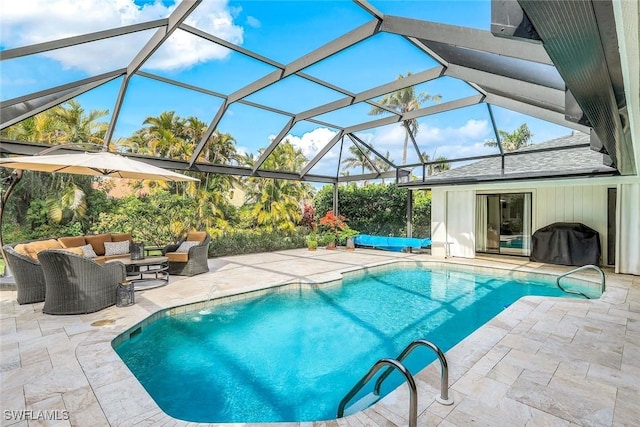 outdoor pool with a patio, outdoor lounge area, and area for grilling