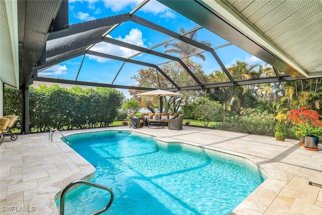 outdoor pool with a patio area and an outdoor hangout area