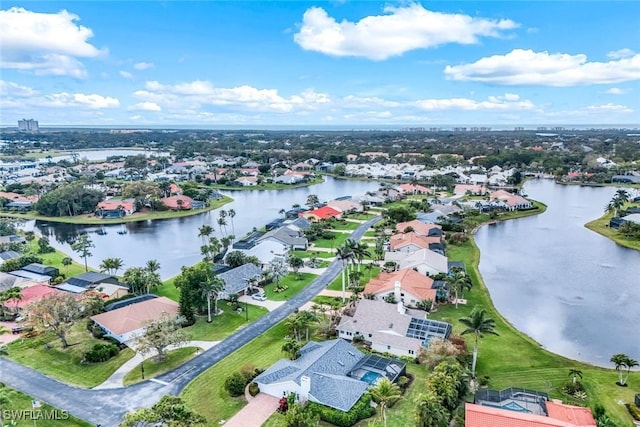 bird's eye view featuring a water view and a residential view