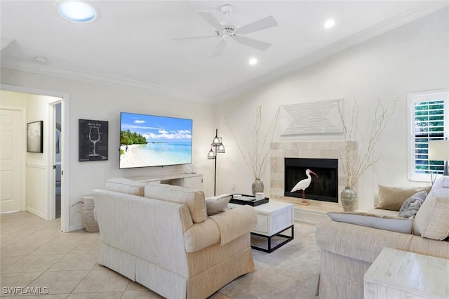 living area featuring light tile patterned floors, recessed lighting, a fireplace, a ceiling fan, and crown molding