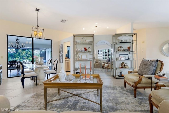 living area with light tile patterned floors, plenty of natural light, a chandelier, and visible vents