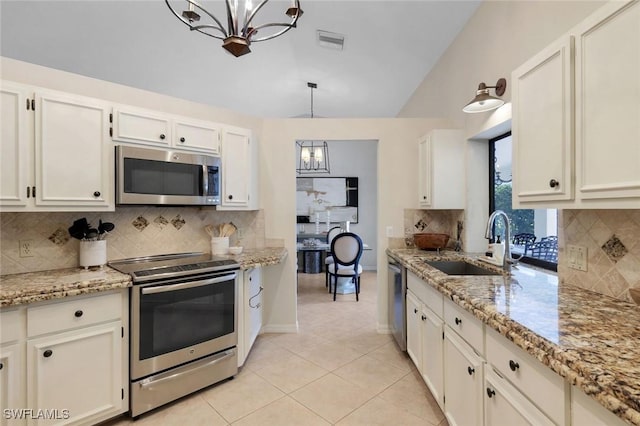 kitchen with lofted ceiling, a notable chandelier, a sink, visible vents, and appliances with stainless steel finishes