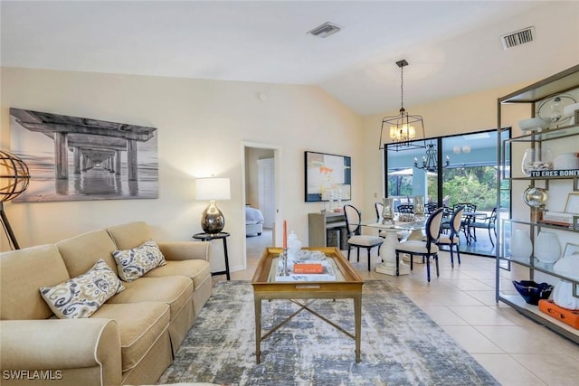 living room with lofted ceiling, visible vents, a chandelier, and tile patterned floors