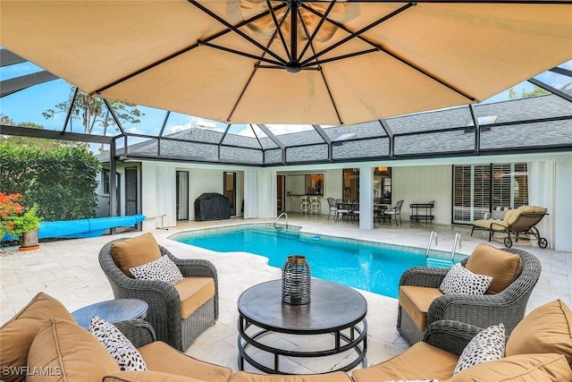 outdoor pool featuring an outdoor hangout area, glass enclosure, grilling area, and a patio area