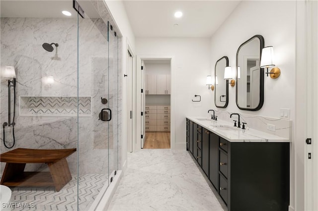 full bath featuring marble finish floor, a sink, a marble finish shower, and double vanity