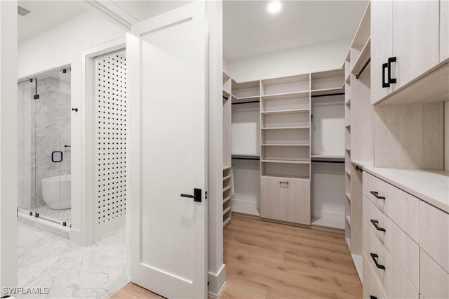 spacious closet with visible vents and light wood-style flooring