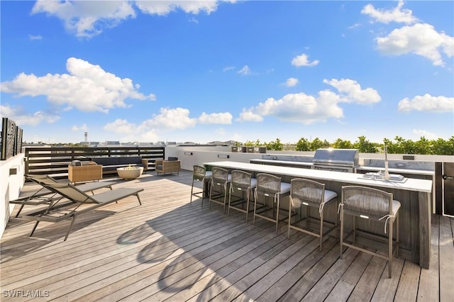 deck featuring outdoor lounge area, area for grilling, and outdoor wet bar