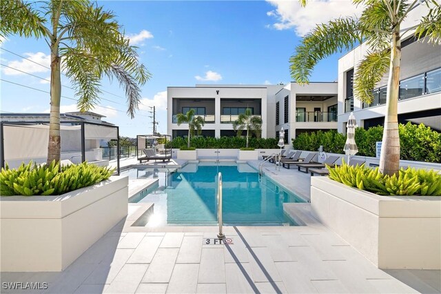 pool with fence and a patio