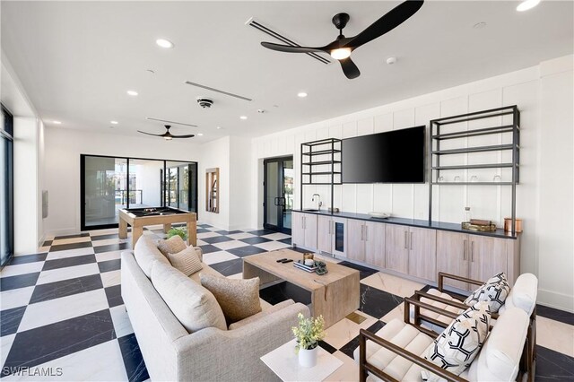 living area with light floors, plenty of natural light, and recessed lighting