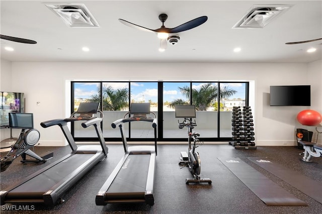 exercise room with a ceiling fan, a wealth of natural light, and visible vents