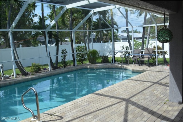 view of pool featuring a fenced in pool, a patio area, a fenced backyard, and a lanai