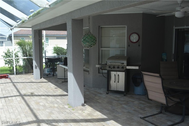 view of patio featuring glass enclosure