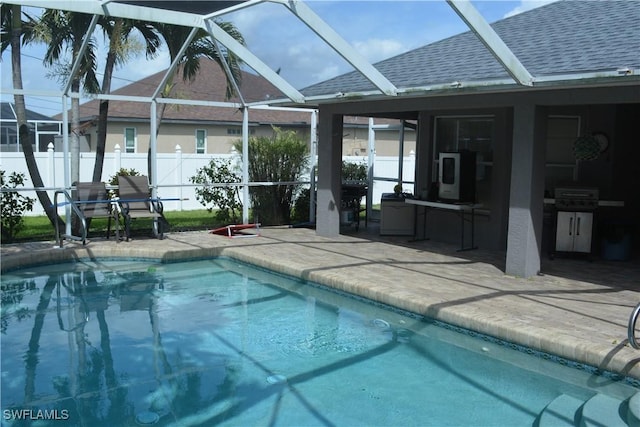 view of pool with a patio, a lanai, area for grilling, fence, and a fenced in pool